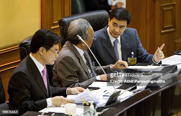 Thai Prime Minister Abhisit Vejjajiva speaks with Thai Deputy Prime Minister Suthep during a parliamentary session at Parliament on May 6, 2010 in...