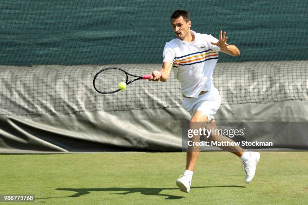 Bernard Tomic of Australia practices on court during training for the Wimbledon Lawn Tennis Championships at the All England Lawn Tennis and Croquet...