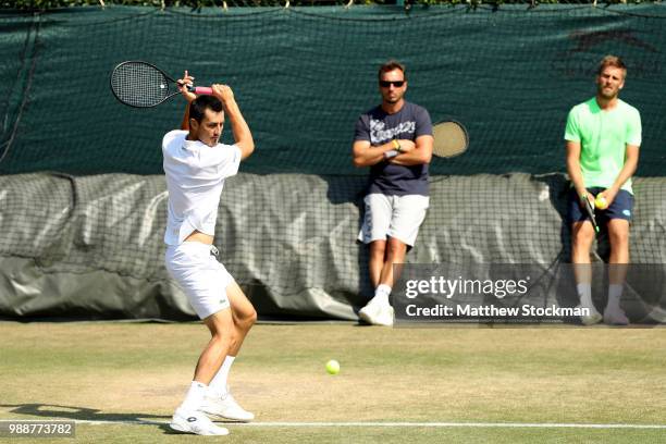 Bernard Tomic of Australia practices on court during training for the Wimbledon Lawn Tennis Championships at the All England Lawn Tennis and Croquet...