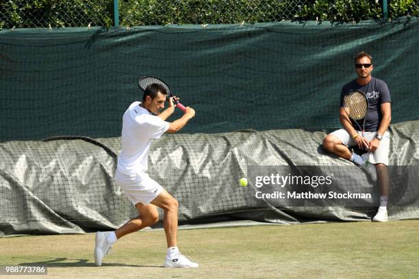 Bernard Tomic of Australia practices on court during training for the Wimbledon Lawn Tennis Championships at the All England Lawn Tennis and Croquet...