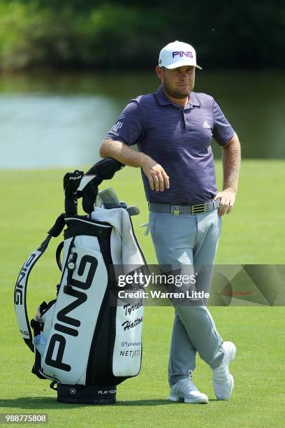 Tyrrell Hatton of England prepares to play his second shot on the 1st hole during day four of the HNA Open de France at Le Golf National on July 1,...