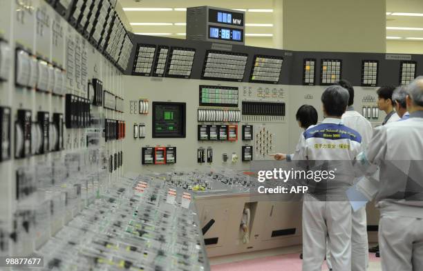 Workers make preparations inside the control room to restart the Monju Prototype Fast Breeder Reactor in Tsuruga, Fukui prefecture, west of Tokyo, on...