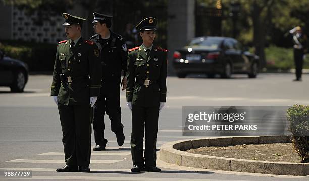 Police stand guard as a diplomatic motorcade enters the Diaoyutai State guest house in Beijing on May 6, 2010. North Korea's leader Kim Jong-Il is...