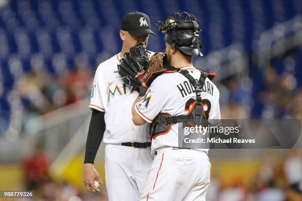 Brad Ziegler of the Miami Marlins talks with Bryan Holaday against the San Francisco Giants at Marlins Park on June 14, 2018 in Miami, Florida.