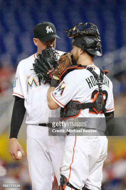 Brad Ziegler of the Miami Marlins talks with Bryan Holaday against the San Francisco Giants at Marlins Park on June 14, 2018 in Miami, Florida.