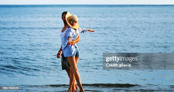 walking on the beach. - gilaxia stock pictures, royalty-free photos & images