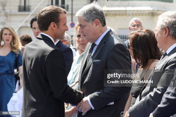 France's President Emmanuel Macron shakes hands with the son of late French politician and Holocaust survivor Simone Veil, Pierre-Francois Veil and...