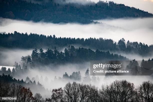 Wafts of mist hanging over the forests near Loitzendorf, in the Lower Bavarian district of Straubing-Bogen, Germany, 11 December 2017. Photo: Armin...