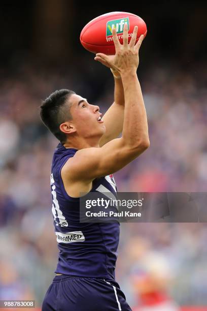 Bailey Banfield of the Dockers marks the ball during the round 15 AFL match between the Fremantle Dockers and the Brisbane Lions at Optus Stadium on...