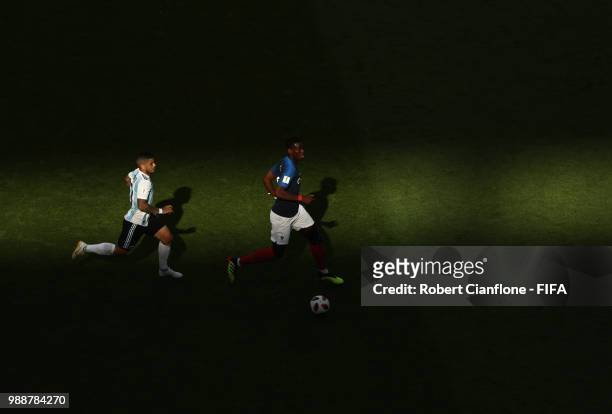 Paul Pogba of France is chased by Ever Banega of Argentina during the 2018 FIFA World Cup Russia Round of 16 match between France and Argentina at...