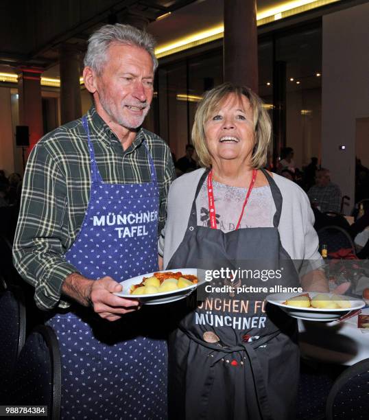 Former national soccer player Paul Breitner and his wife Hildegard supporting the Munchner Tafel e.V. During the distribution of food in the Old...