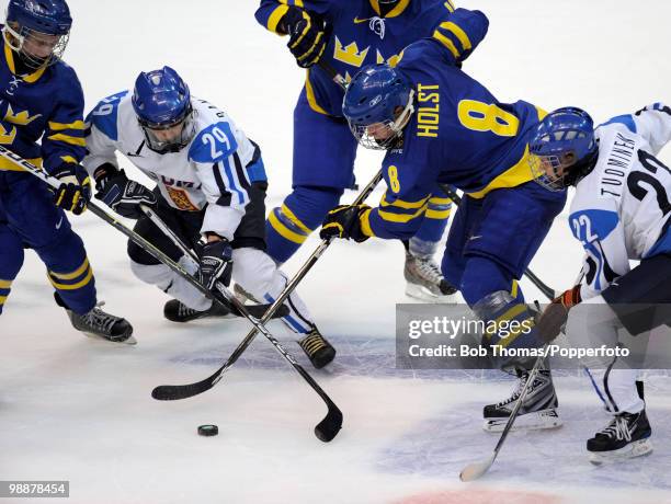 Karoliina Rantamaki with Saara Tuominen of Finland clash with Elin Holmlov and Erika Holst of Sweden during the ice hockey women's bronze medal game...