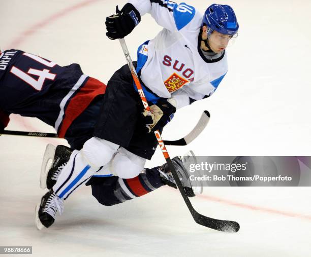 Ville Peltonen of Finland with Brooks Orpik of the USA during the ice hockey men's semifinal game between the United States and Finland on day 15 of...