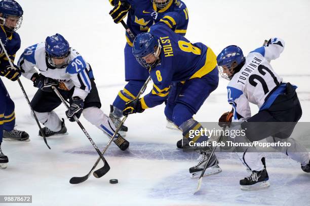 Karoliina Rantamaki with Saara Tuominen of Finland clash with Elin Holmlov and Erika Holst of Sweden during the ice hockey women's bronze medal game...