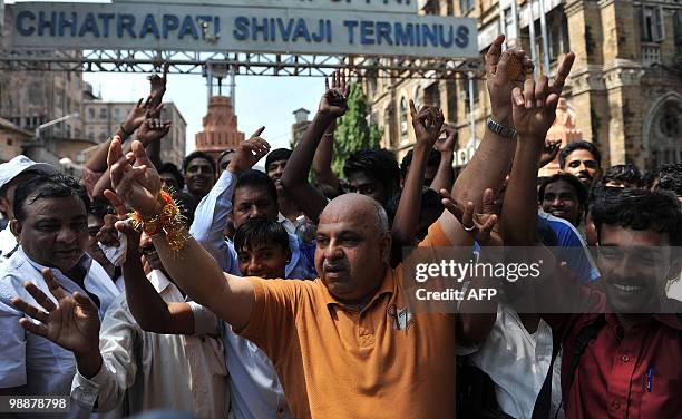 People celebrate the death penalty sentencing of Mohammed Ajmal Amir Kasab outside the Chattrapathi Shivaji Terminus railway station, one of the 2008...