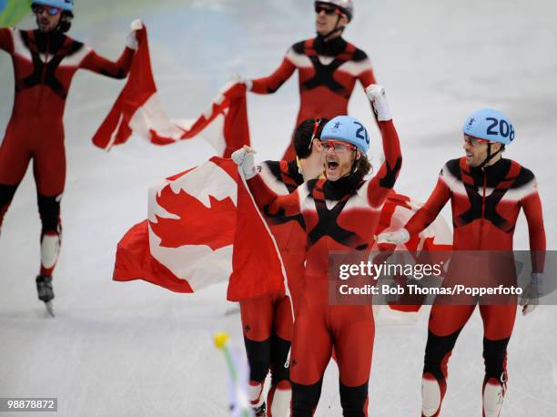 Olivier Jean of Canada leads the celebrations after Canada won the gold medal in the Men's 5000m Relay Short Track Speed Skating Final on day 15 of...