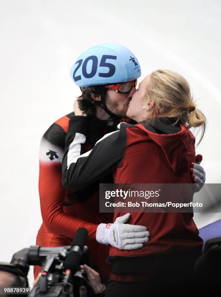 Gold medallist Charles Hamelin kisses his girlfriend and fellow Canadian short-track skater Marianne St-Gelais as he celebrates at the end of the...