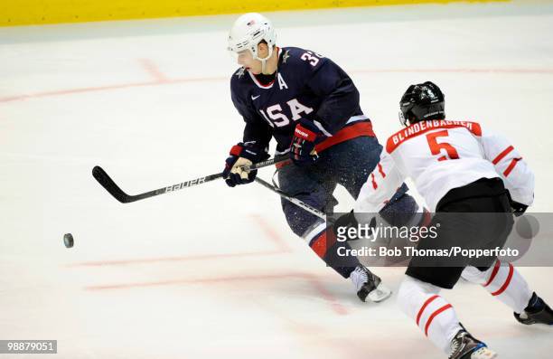 Dustin Brown of the USA with Severin Blindenbacher of Switzerland during the ice hockey men's preliminary game between the USA and Switzerland on day...