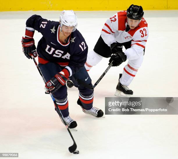 Ryan Malone of the USA with Ivo Ruthemann of Switzerland during the ice hockey men's preliminary game between the USA and Switzerland on day 5 of the...