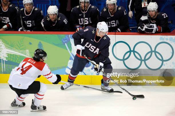 Zach Parise of the USA with Roman Wick of Switzerland during the ice hockey men's preliminary game between the USA and Switzerland on day 5 of the...