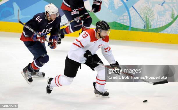 Thierry Paterlini of Switzerland with Bobby Ryan of the USA during the ice hockey men's preliminary game between the USA and Switzerland on day 5 of...