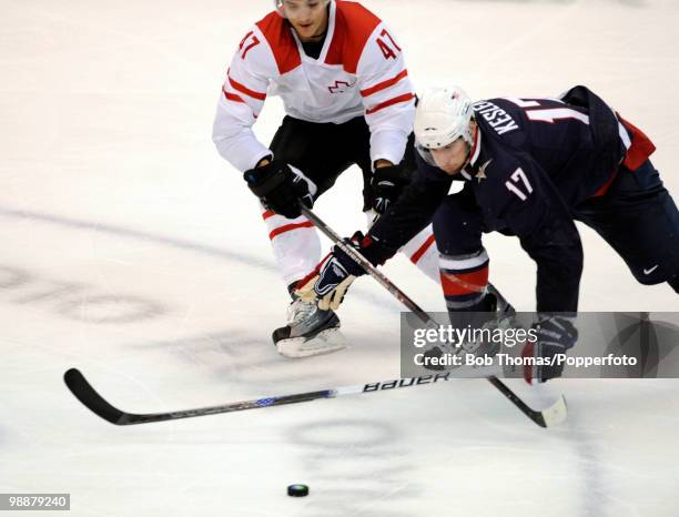 Ryan Kesler of the USA with Luca Sbisa of Switzerland during the ice hockey men's preliminary game between the USA and Switzerland on day 5 of the...