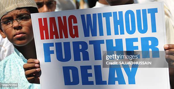 An Indian Muslim child holds a placard during a rally celebrating the sentencing of Mohammed Ajmal Amir Kasab in Mumbai on May 6, 2010. The lone...
