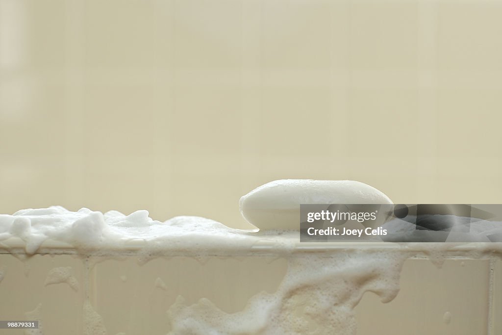 Bar of soap with suds in the bath