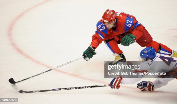 Sergei Zinovyev of Russia with Zbynek Michalek of the Czech Republic during the ice hockey men's preliminary game between Russia and the Czech...