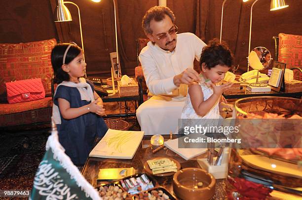 Saudi Prince Alwaleed bin Talal, center, plays with his grandchildren Princess Jena Bin Khaled Bint Alwaleed Bin Talal Bin Abdulaziz Alsaud right,...
