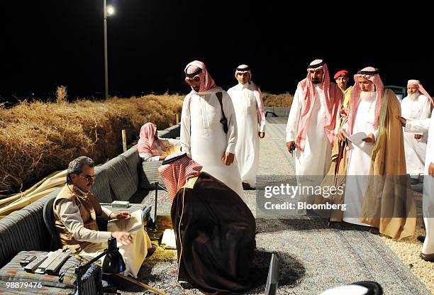 Saudi Prince Alwaleed bin Talal, left, meets citizens who have lined up to ask for the Prince's assistance at the desert camp near Riyadh, Saudi...