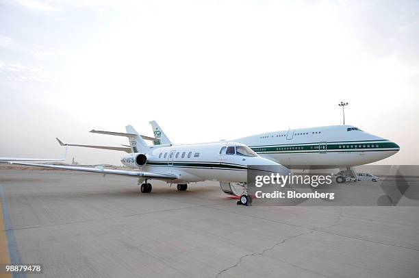 Hawker jet, left, and a Boeing 747 private airplanes belonging to Saudi Prince Alwaleed bin Talal sit on the tarmac at the private aviation terminal...