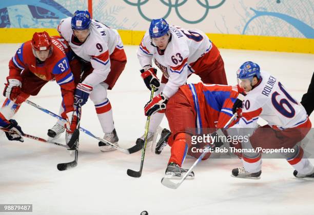 Russian players Denis Grebeshov and Pavel Datsyuk try to reach the puck with the Czech Republic's Milan Michalek , Josef Vasicek and Tomas Rolinek...