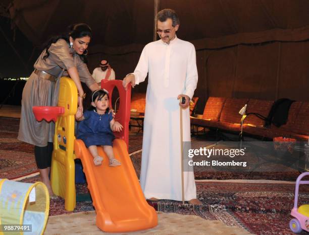 Saudi Prince Alwaleed bin Talal, right, his wife Princess Amira Al-Taweel, left, play with the Prince's grandchild Princess Sarah Bint Abdulaziz Bin...