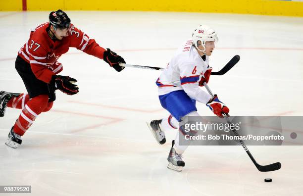 Jonas Holos of Norway with Patrice Bergeron of Canada during the Canada v Norway ice hockey men's preliminary game on day 5 of the Vancouver 2010...