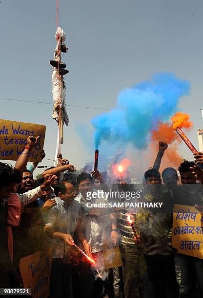 Indian citizens set off flairs underneath a hanged effigy of Mohammed Ajmal Amir Kasab in Ahmedabad on May 6, 2010. The lone surviving gunman from...