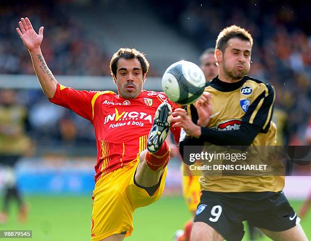 Lens's defender Marco Ramos vies with Grenoble's forward Josip Tadic during the French L1 football match Lens vs. Grenoble on May 5, 2010 at Felix...