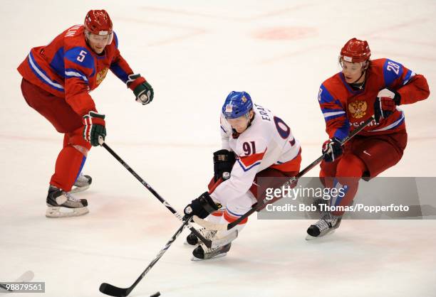 Martin Erat of the Czech Republic with Ilya Nikulin and Alexander Semin of Russia during the ice hockey men's preliminary game between Russia and the...