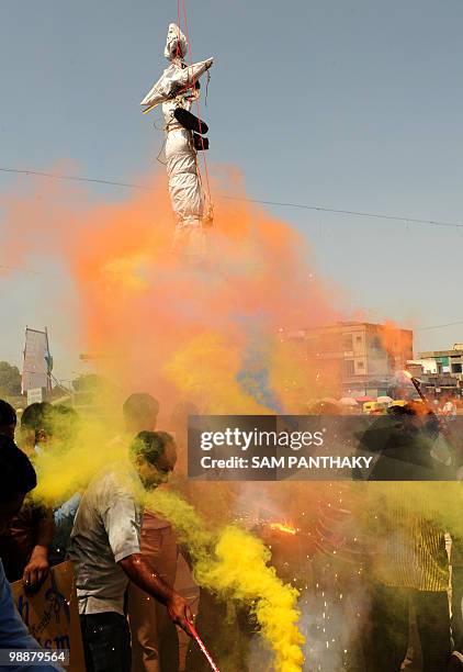 Indian citizens set off flairs underneath a hanged effigy of Mohammed Ajmal Amir Kasab in Ahmedabad on May 6, 2010. The lone surviving gunman from...