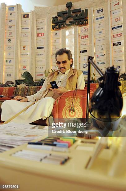 Saudi Prince Alwaleed bin Talal, uses his cell phone at the desert camp near Riyadh, Saudi Arabia, on Wednesday, April 28, 2010. Alwaleed said he...