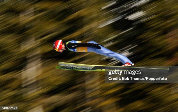 Kamil Stoch of Poland competes in the men's ski jumping team event on day 11 of the 2010 Vancouver Winter Olympics at Whistler Olympic Park Ski...