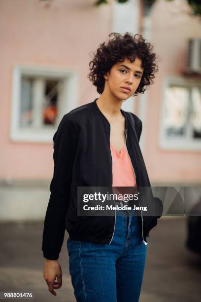 Georgian model Gvantsa Revazishvili wears a black jacket, pink tanktop, and blue jeans during Mercedes-Benz Fashion Week Tbilisi Fall/Winter 2018 on...