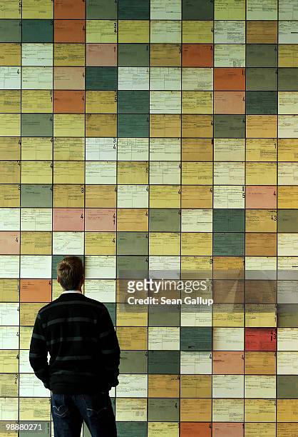 Visitor looks at an exhibit of index cards from the post-World War II investigation of members of the Reich Security Main Office , one of the main...