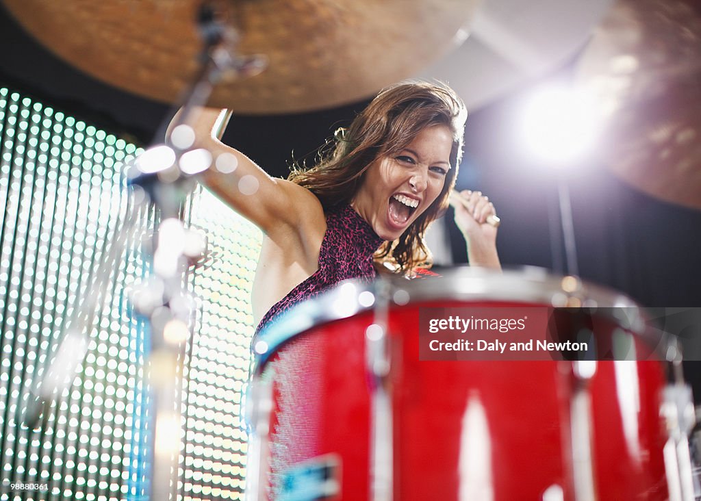 Young woman playing drums