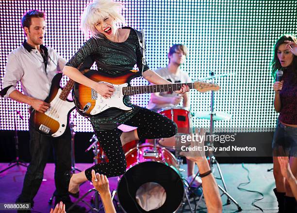 rock band performing on stage - performance group stock pictures, royalty-free photos & images