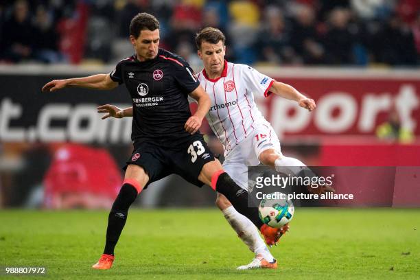 Dusseldorf's Lukas Schmitz and Nuremberg's Georg Margreitter vying for the ball during the German 2nd Bundesliga soccer match between Fortuna...