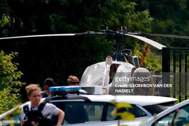 This picture taken on July 1, 2018 in Gonesse, north of Paris shows police near a French helicopter Alouette II abandoned by French armed robber...