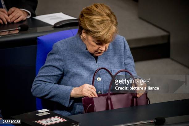 German Chancellor Angela Merkel attends a session of the lower house of parliament at the Bundestag in Berlin, Germany, 12 December 2017. Photo:...