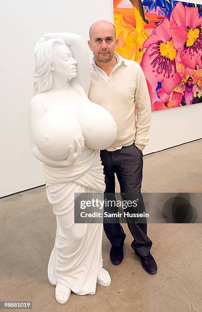 Artist Marc Quinn poses with one of his sculpture of Chelsea Charms at his new exhibition 'Marc Quinn: Allanah, Buck, Catman, Michael, Pamela &...