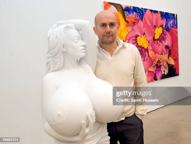 Artist Marc Quinn poses with one of his sculpture of Chelsea Charms at his new exhibition 'Marc Quinn: Allanah, Buck, Catman, Michael, Pamela &...